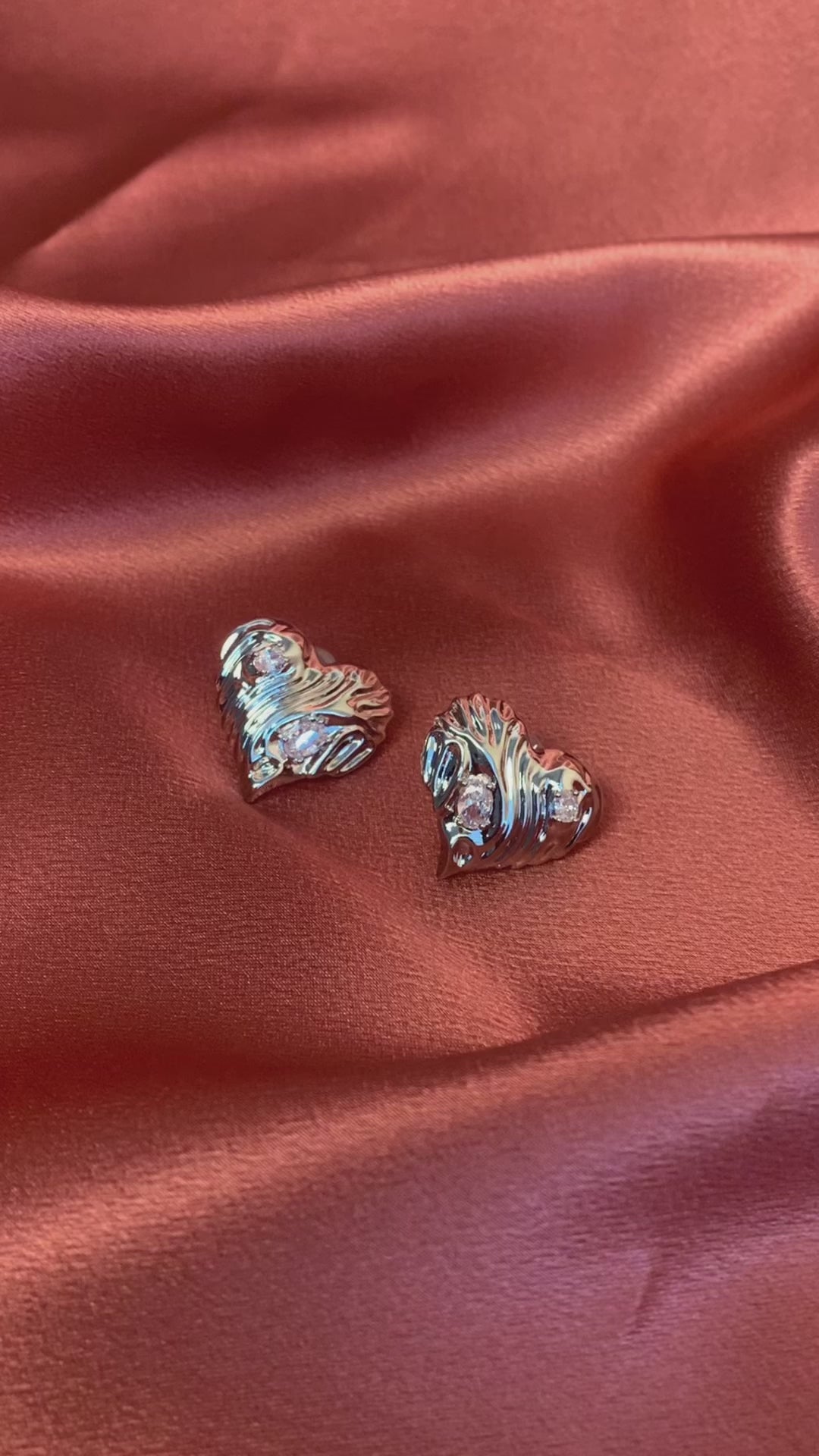 Minimalist silver heart-shaped statement stud earrings with diamonds—ideal for a chic and sophisticated look