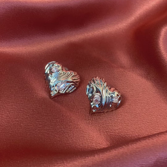 Minimalist silver heart-shaped statement stud earrings with diamonds—ideal for a chic and sophisticated look